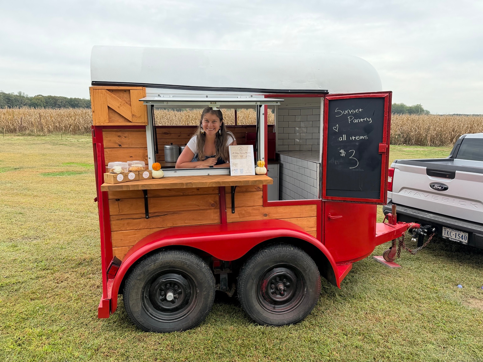 The Sunset Pantry trailer with a smiling baker at the open serving window